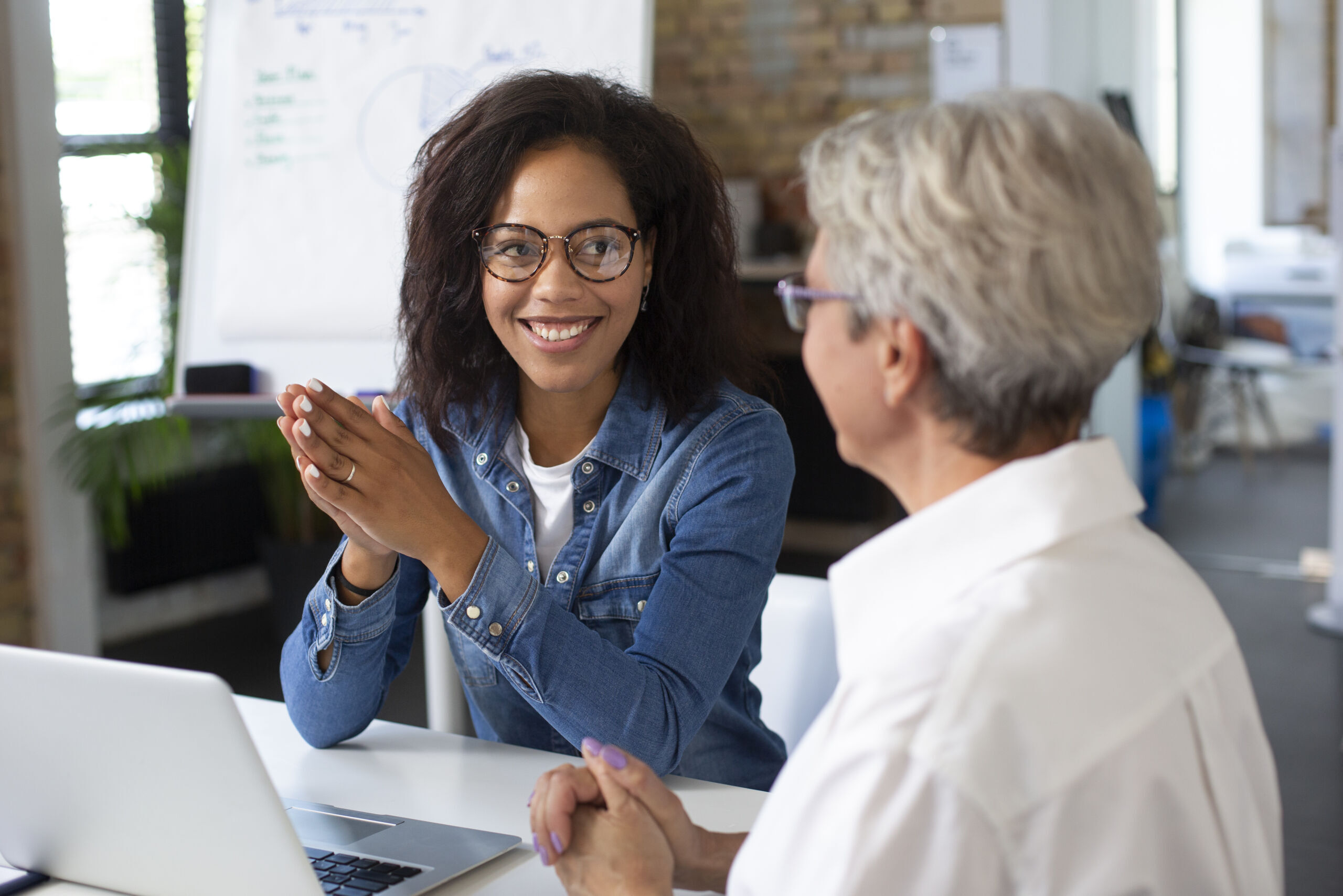 Two women sitting at a table having a mentorship discussion